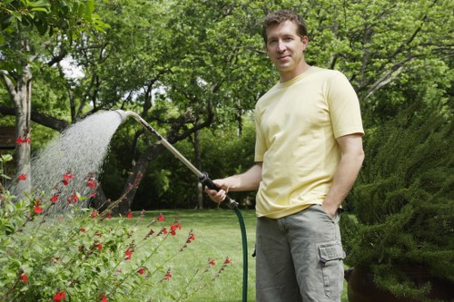Close-up of gardener taking notes beside a flower bed